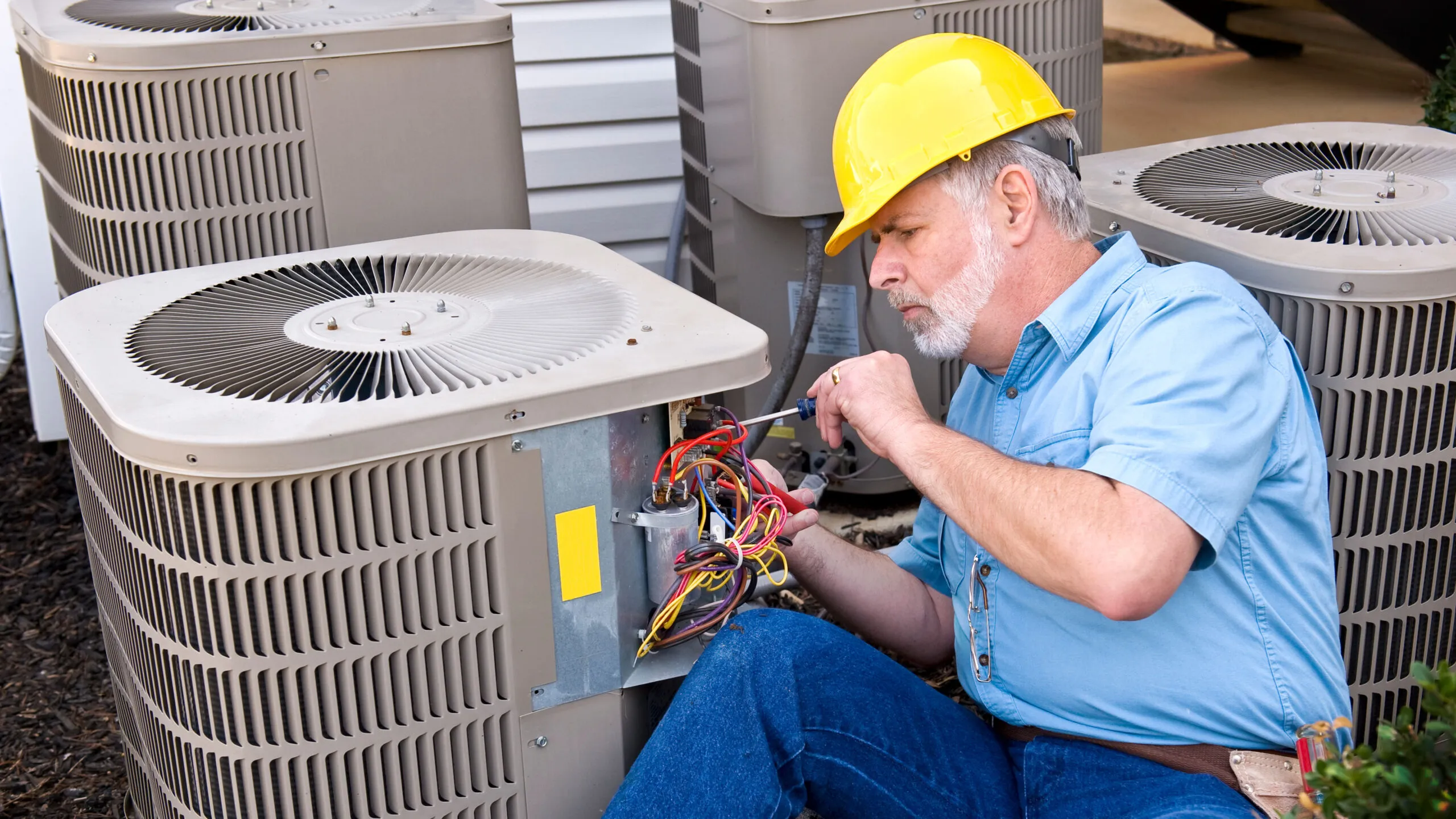 Green Air Heating and Cooling technician performing an HVAC maintenance check.