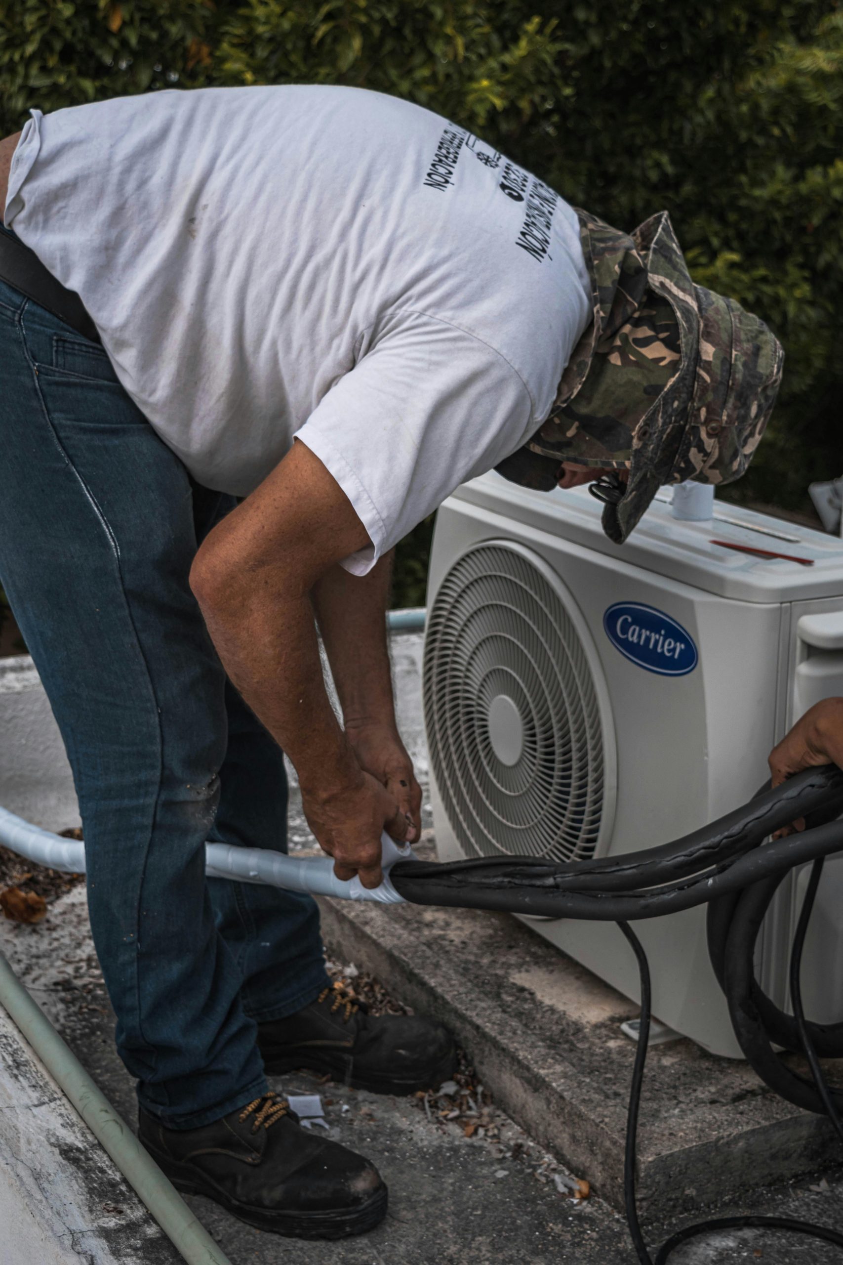 HVAC technician performing routine maintenance on an air conditioning system in Las Vegas.